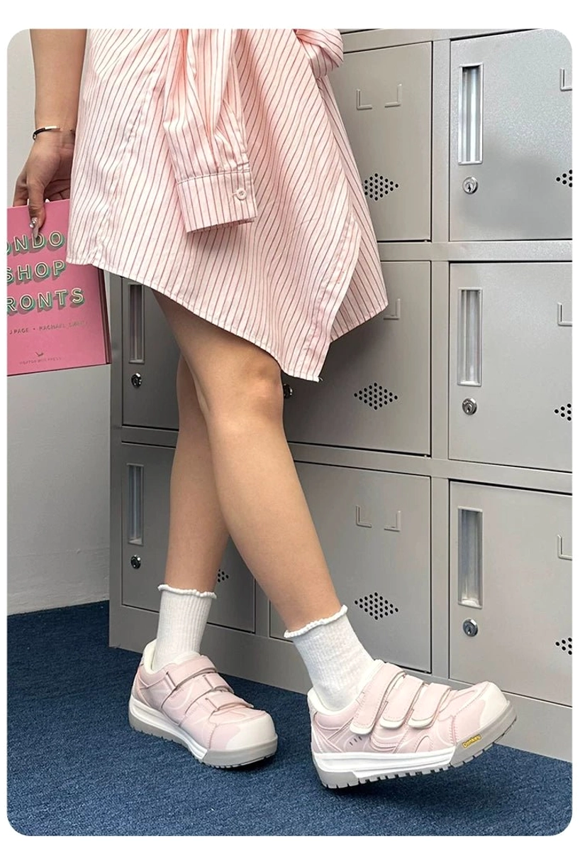 Front-side detail of pink triple strap platform sneakers showing the three Velcro closures and thick rubber outsole