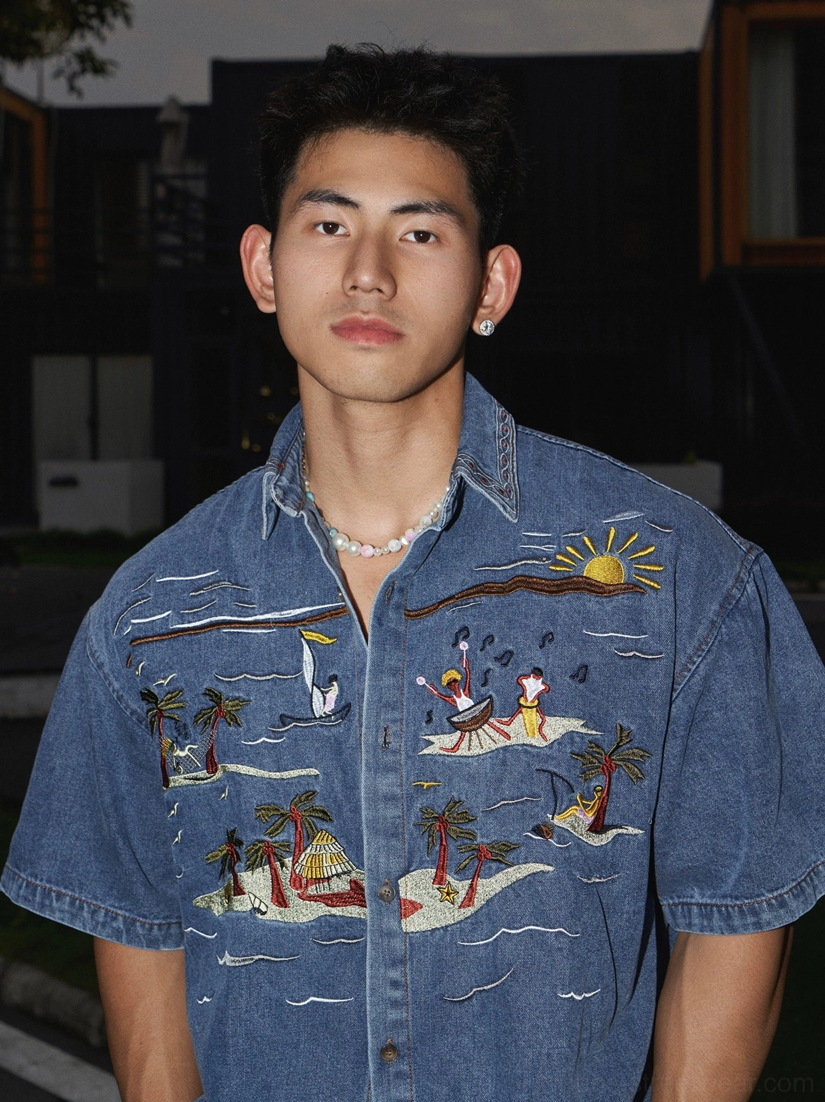 Short sleeve tropical embroidered denim shirt in washed indigo blue with palm tree sunset artwork and relaxed Korean streetwear fit