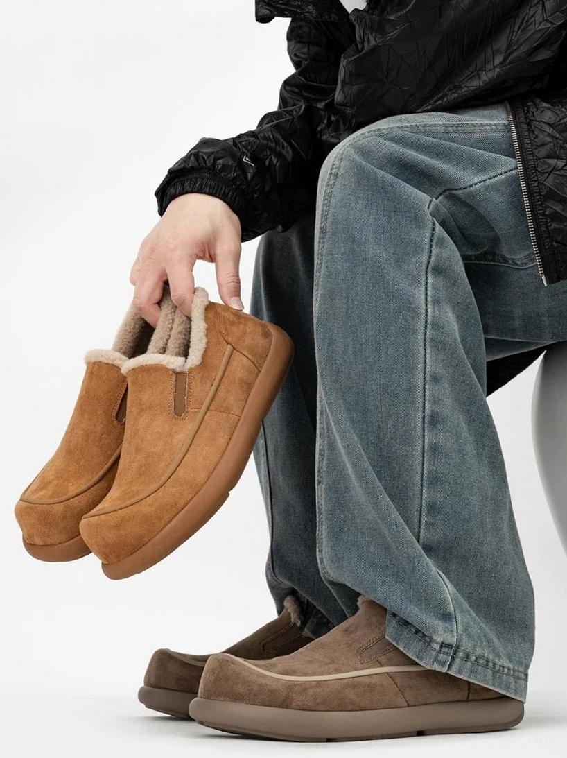 Two-tone shearling slip-on clogs in dark brown and chestnut brown, shown on foot with a foldable flexible outsole and warm fleece lining