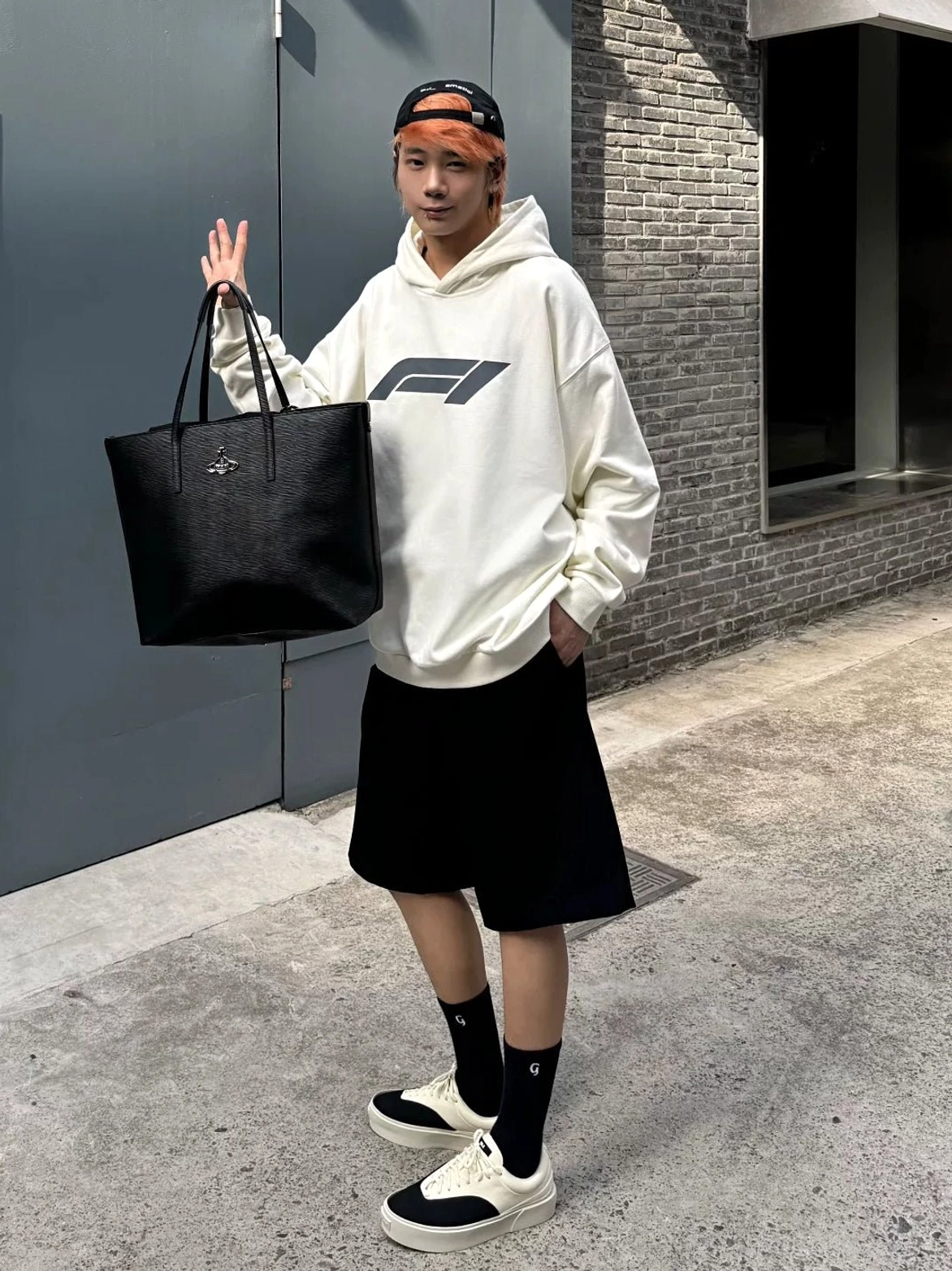 Full-body urban streetwear outfit featuring two-tone black and off-white canvas platform skate shoes and a black tote bag