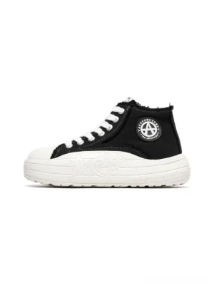 Black and white two-tone canvas high-top platform sneakers with white toe cap, thick sole, side badge, and frayed ankle collar
