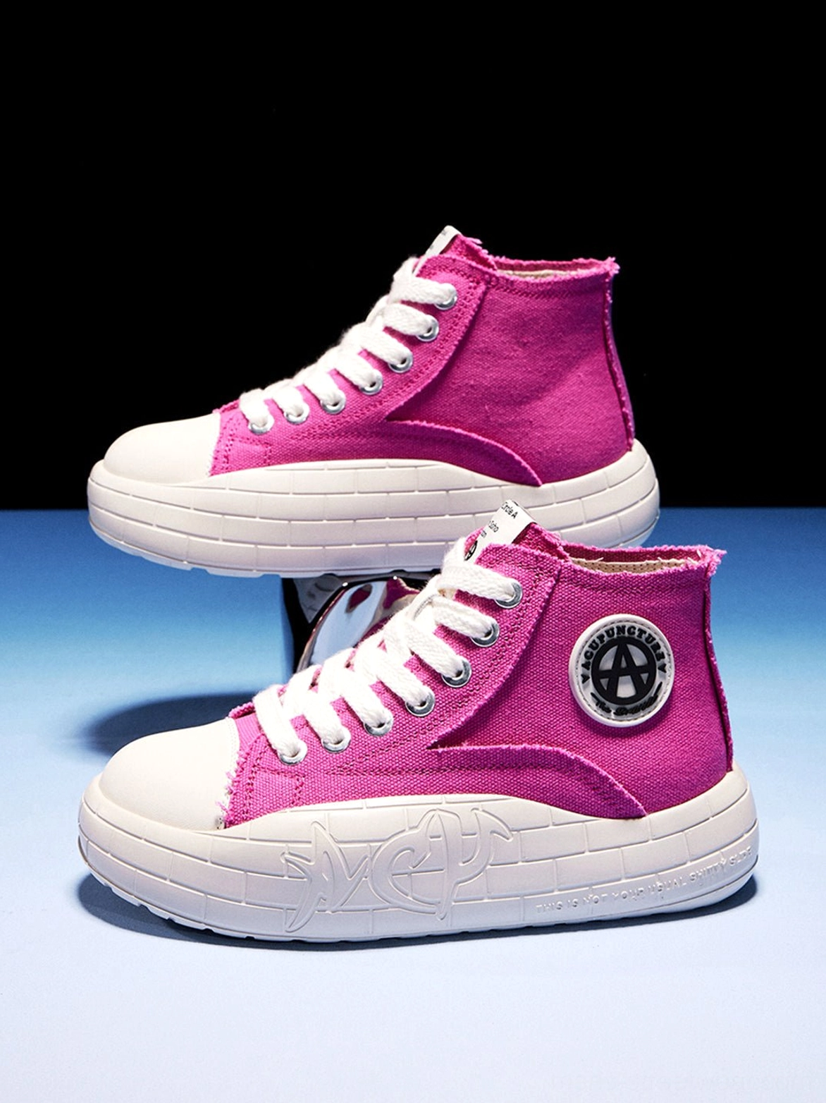 Two-tone canvas platform high-tops designed to add a graphic elevated profile to casual outfits