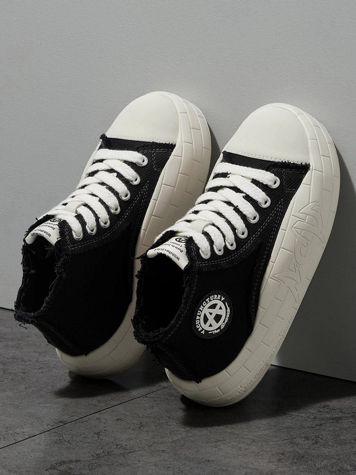 Overhead view of black and white canvas platform high-tops showing the ankle opening and inner sole