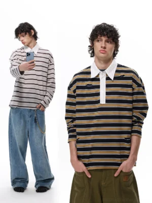 Oversized two-tone striped rugby shirt with contrast white collar and half-button placket styled with denim in a minimalist studio