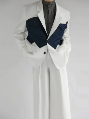 Front view of a two-tone ivory and navy Western color-block blazer with jagged denim-style chest pockets and matching wide-leg trousers