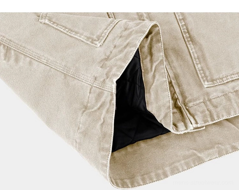 Two-tone cotton canvas work jacket pocket close-up showing oversized front patch pocket and black quilted inner lining