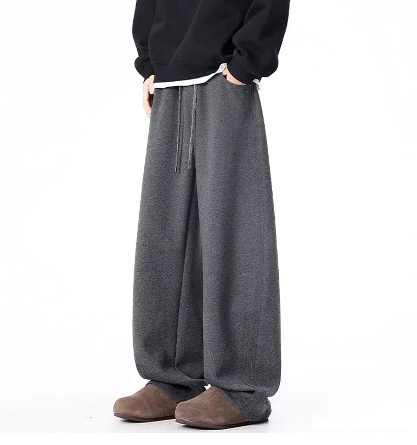 Side front view of dark gray ultra-wide sweatpants with relaxed draped wide-leg fit