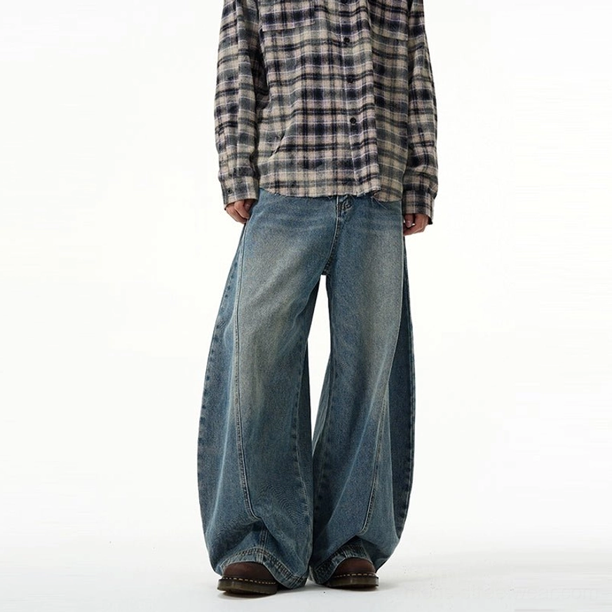 Ultra wide-leg balloon jeans in vintage washed blue showing the oversized streetwear silhouette and relaxed denim fit