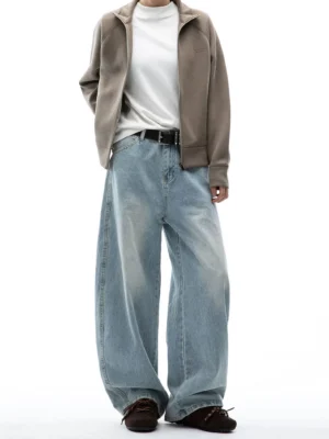 Model wearing light blue ultra wide-leg washed jeans with a brown zip jacket, white T-shirt, dark belt, and vintage leather shoes in a Korean streetwear outfit