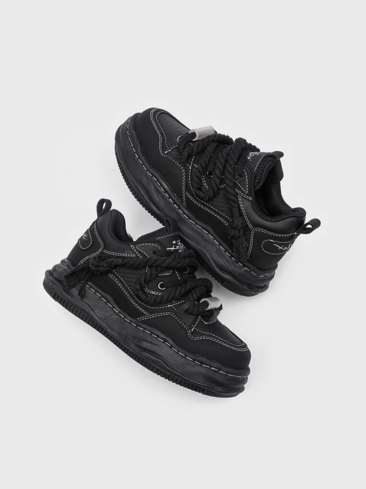 Unisex black chunky wavy platform sneakers designed to anchor baggy denim, cargo pants, oversized layers, and avant-garde outfits