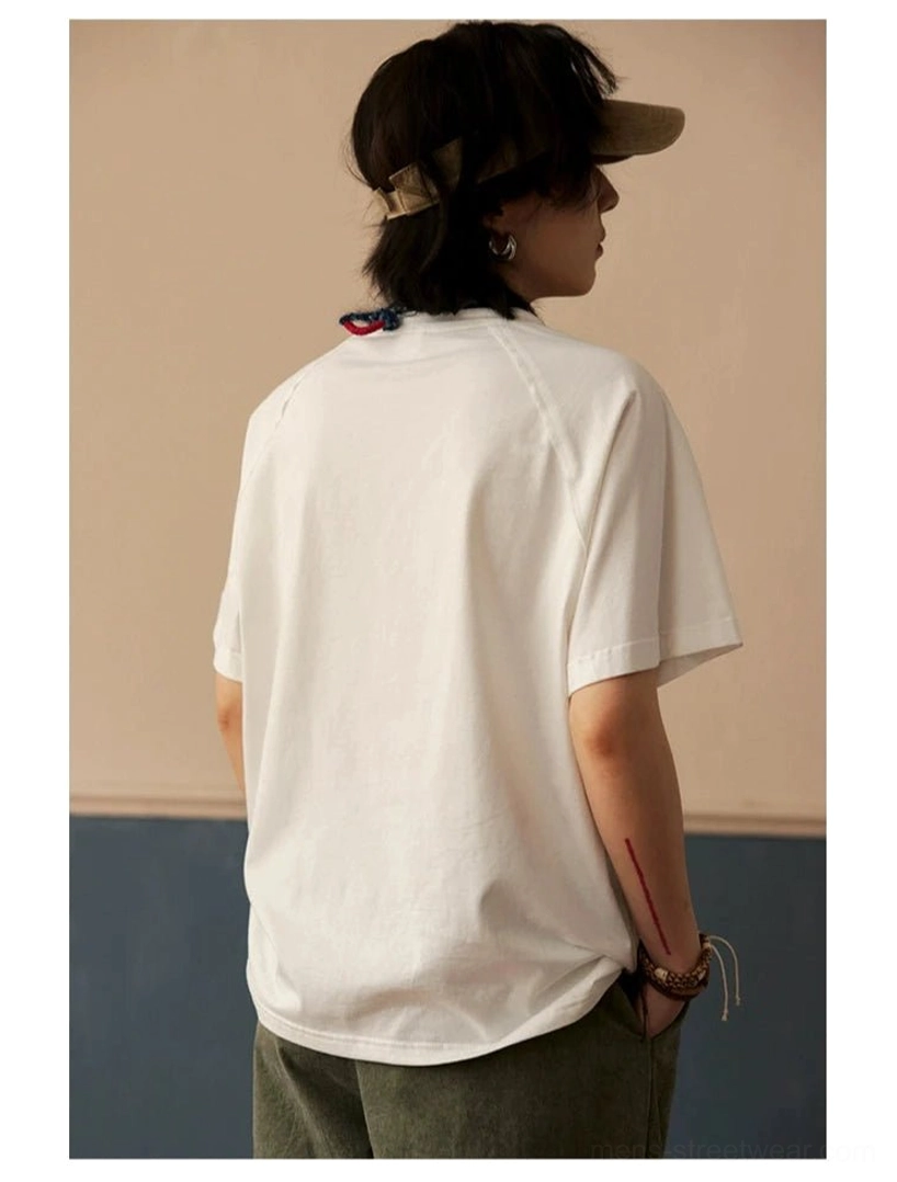 Unisex-inspired cotton raglan sleeve T-shirt with clean crew neck and modern loose streetwear fit
