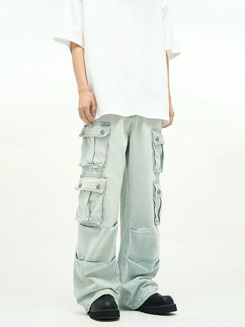 Unisex light wash cargo jeans styled with an oversized white T-shirt and chunky black sneakers, showing multi-pocket wide-leg denim