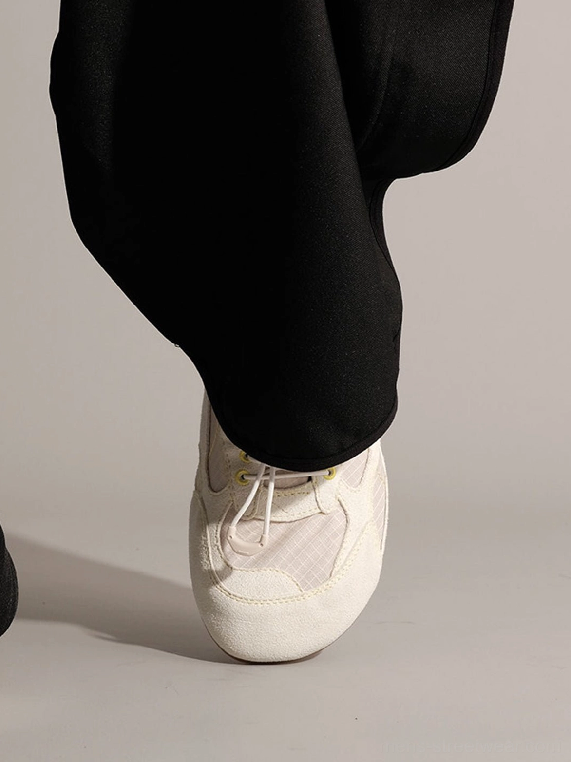 Unisex low-profile nubuck streetwear trainers featuring mixed-material paneling and flexible rubber outsole