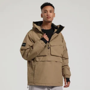 Khaki utility anorak snow jacket with high collar hood half zip and multiple cargo pockets on male model