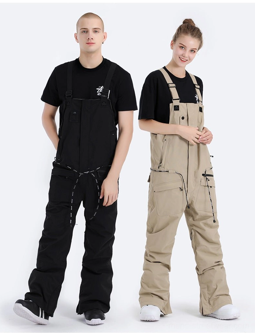 Two models wearing unisex utility bib snow pants in a full front view with tailored outdoor silhouettes, straight legs, adjustable suspenders, and multiple zip pockets