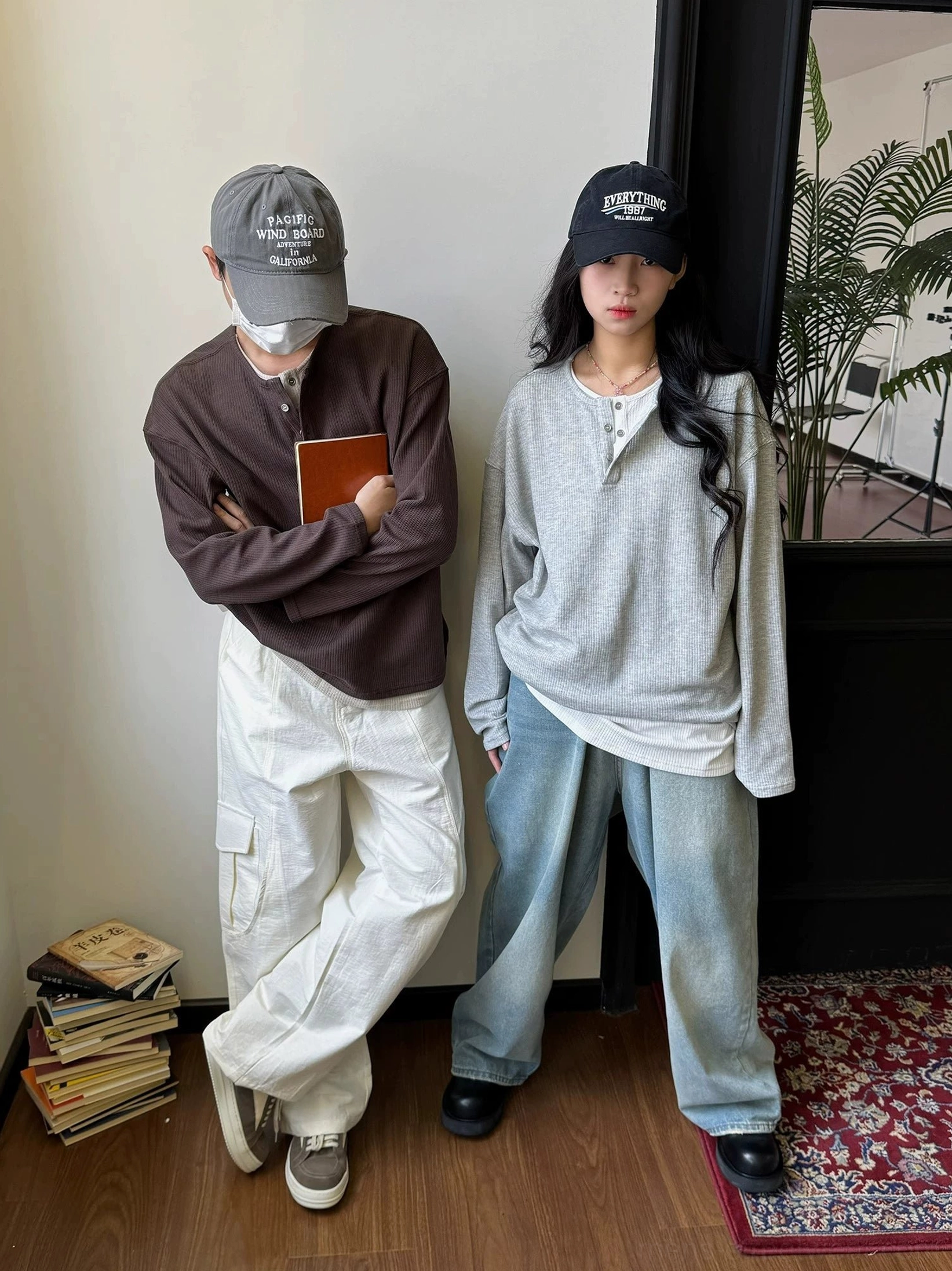 Male and female models in loose dark brown and heather gray waffle knit Henley shirts for casual East Asian streetwear