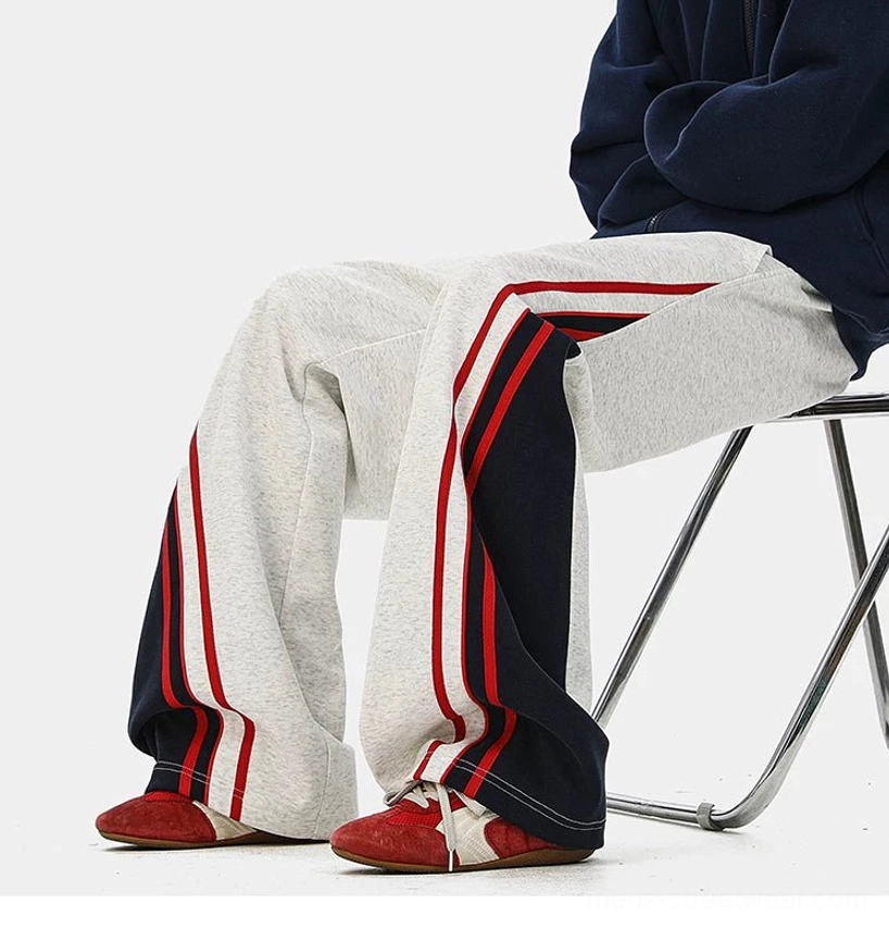 Unisex wide-leg varsity track pants with athletic side stripes, relaxed fit, and versatile casual streetwear styling