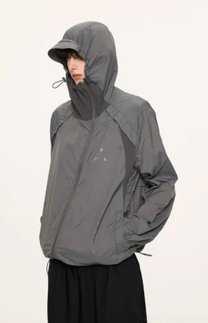 Dark gray UPF 50 plus UV protection hooded jacket shown from the front left side with adjustable hood, front zipper, side pockets, and relaxed streetwear fit