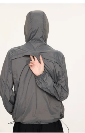 Dark gray lightweight UV protection hooded jacket shown from the back with stitched back panel, adjustable hem drawcord, and loose techwear silhouette