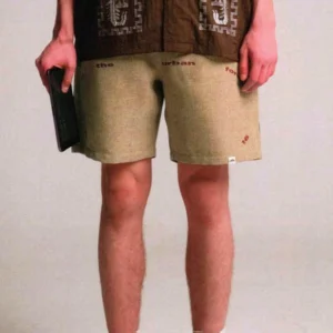 Khaki urban text graphic relaxed shorts with casual drawstring waist and loose streetwear fit