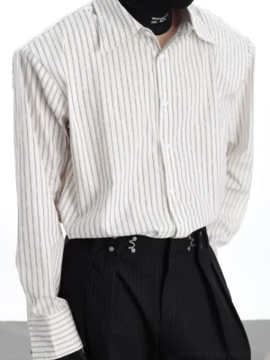 Close-up detail of the vertical stripe Oxford shirt showing pointed collar striped cuffs tailored shoulder seams and button placket