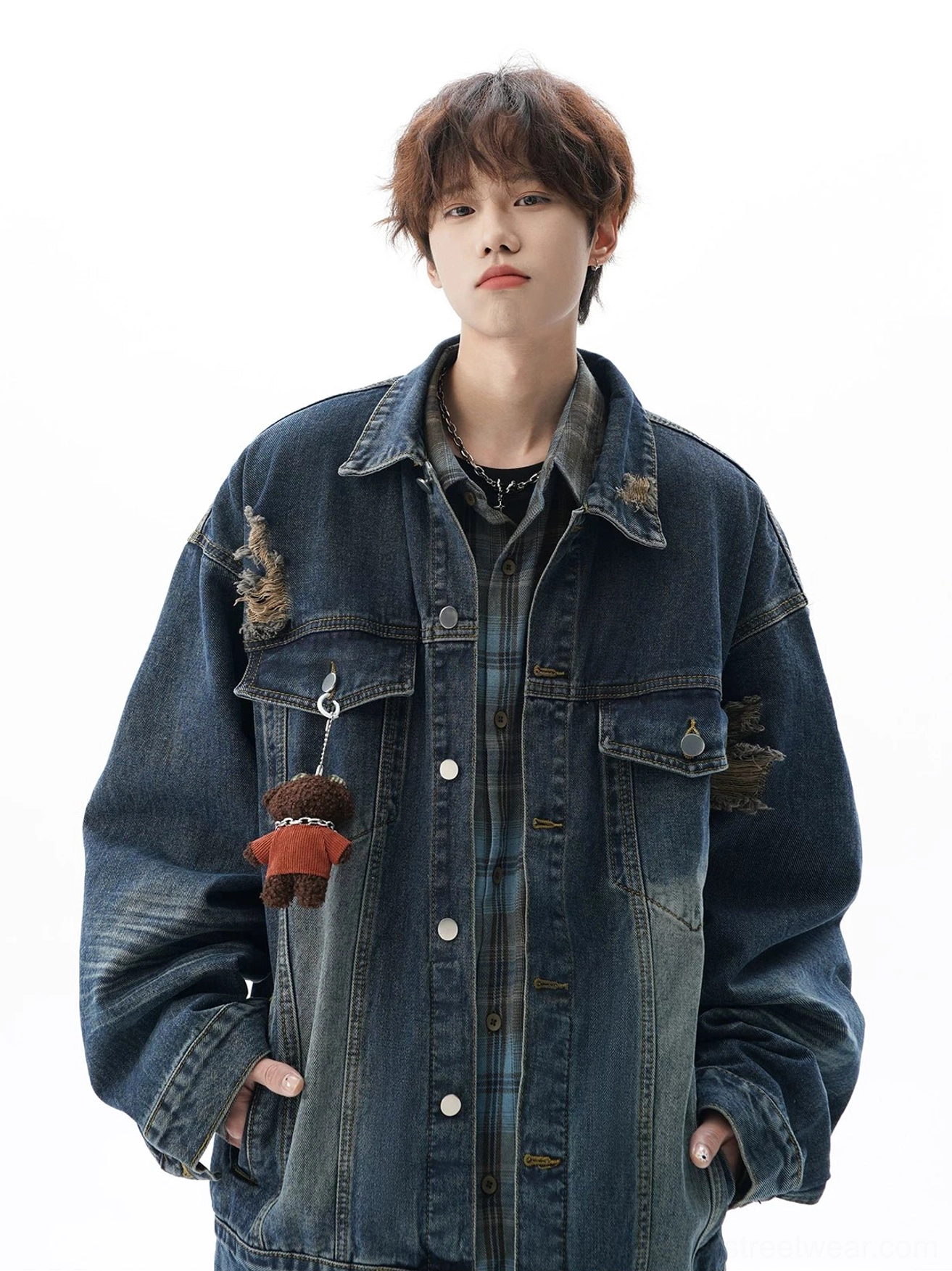 Vintage black denim jacket with loose unisex silhouette, aged fade effect, chest flap pockets, and contemporary urban layering potential