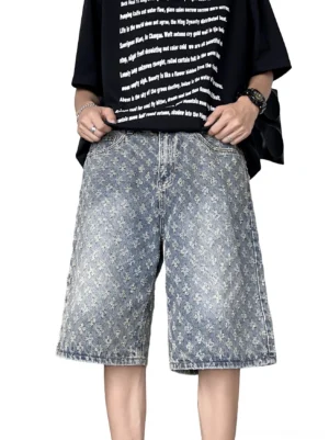Front low-angle view of vintage blue floral jacquard denim Bermuda shorts with loose wide-leg streetwear fit and distressed washed finish