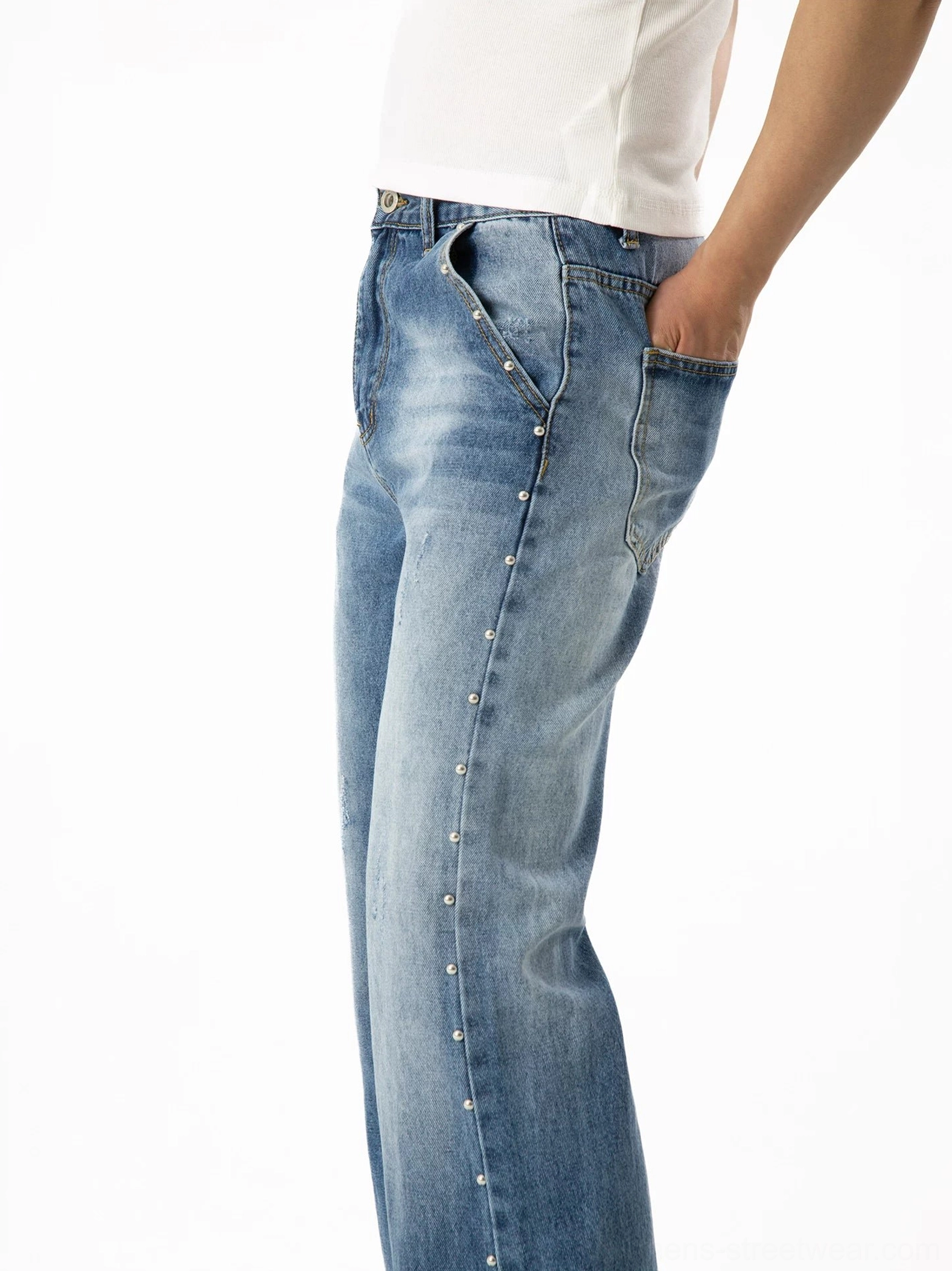 Rear side view of vintage blue studded flare denim jeans showing outer seam rivets, classic back pockets, and wide flared leg opening