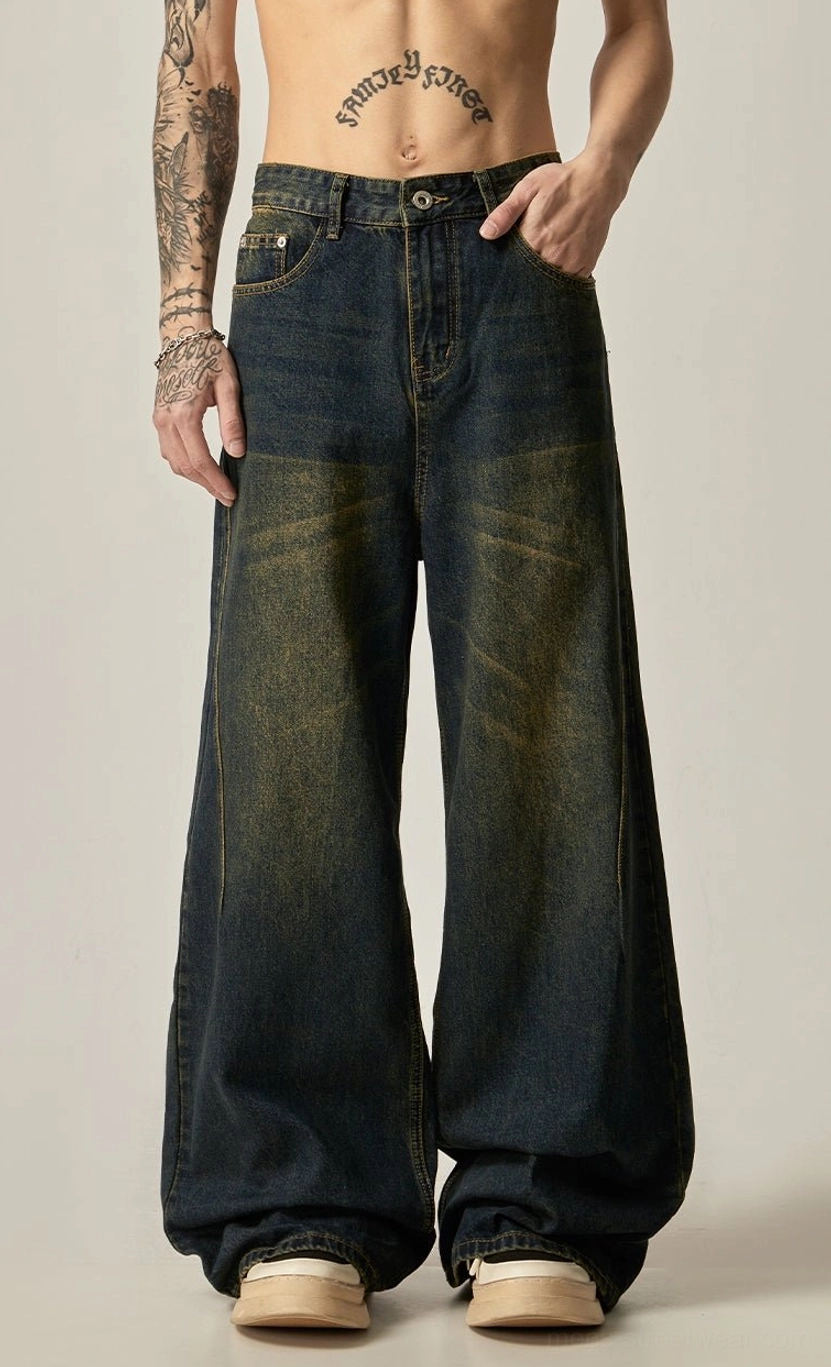 Front view of vintage blue ultra-wide leg jeans with yellow water-wash patina styled with platform loafers