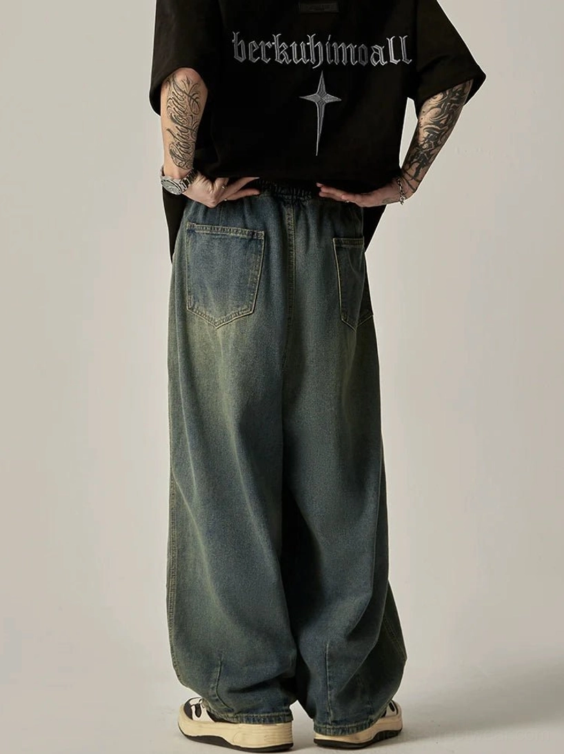 Back view of vintage blue washed wide-leg jeans with double rear patch pockets and elasticated streetwear waist