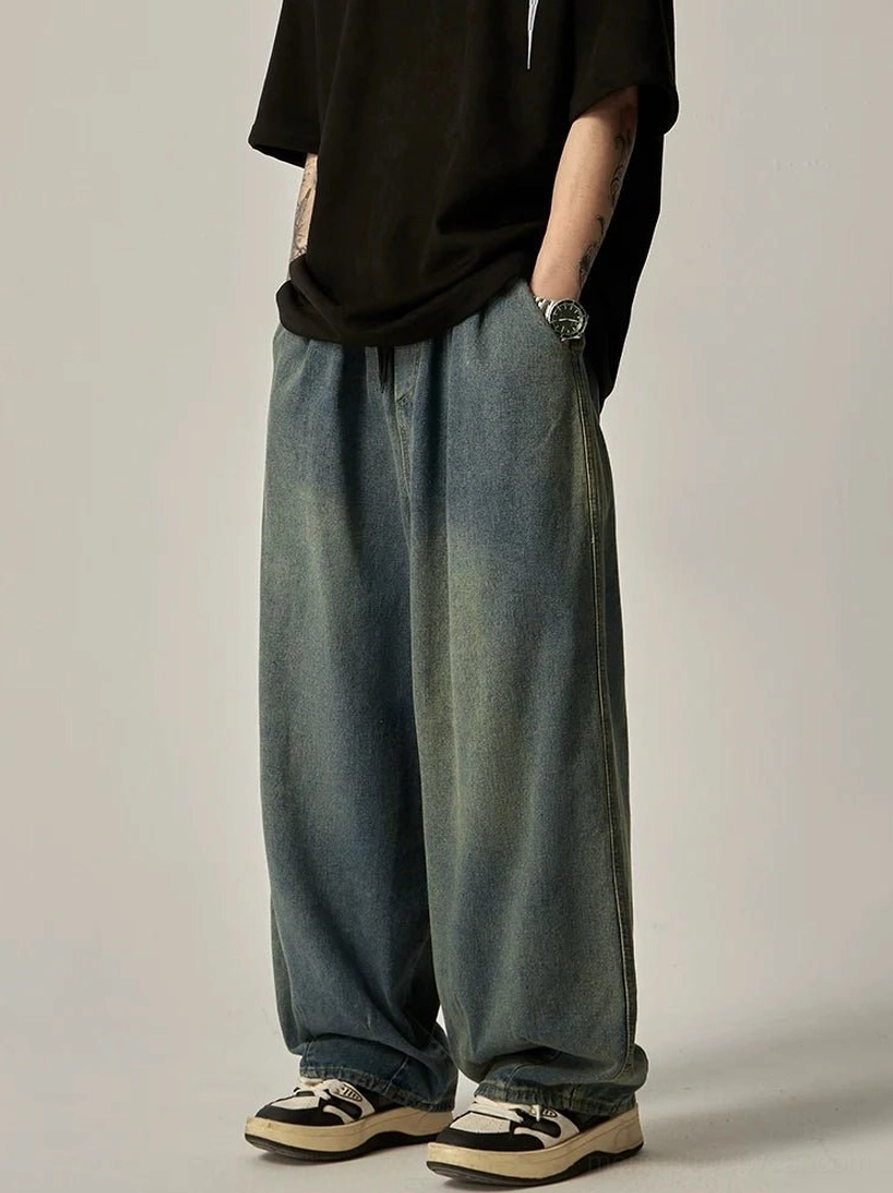 Side view of vintage blue wide-leg jeans with loose relaxed silhouette and casual skate streetwear styling
