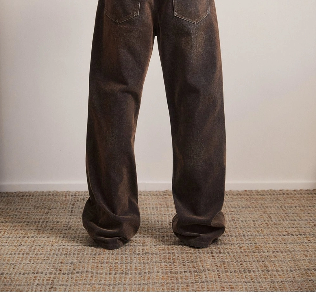 Vintage brown flare jeans back view showing rear pocket stitching wide flared legs and washed denim texture
