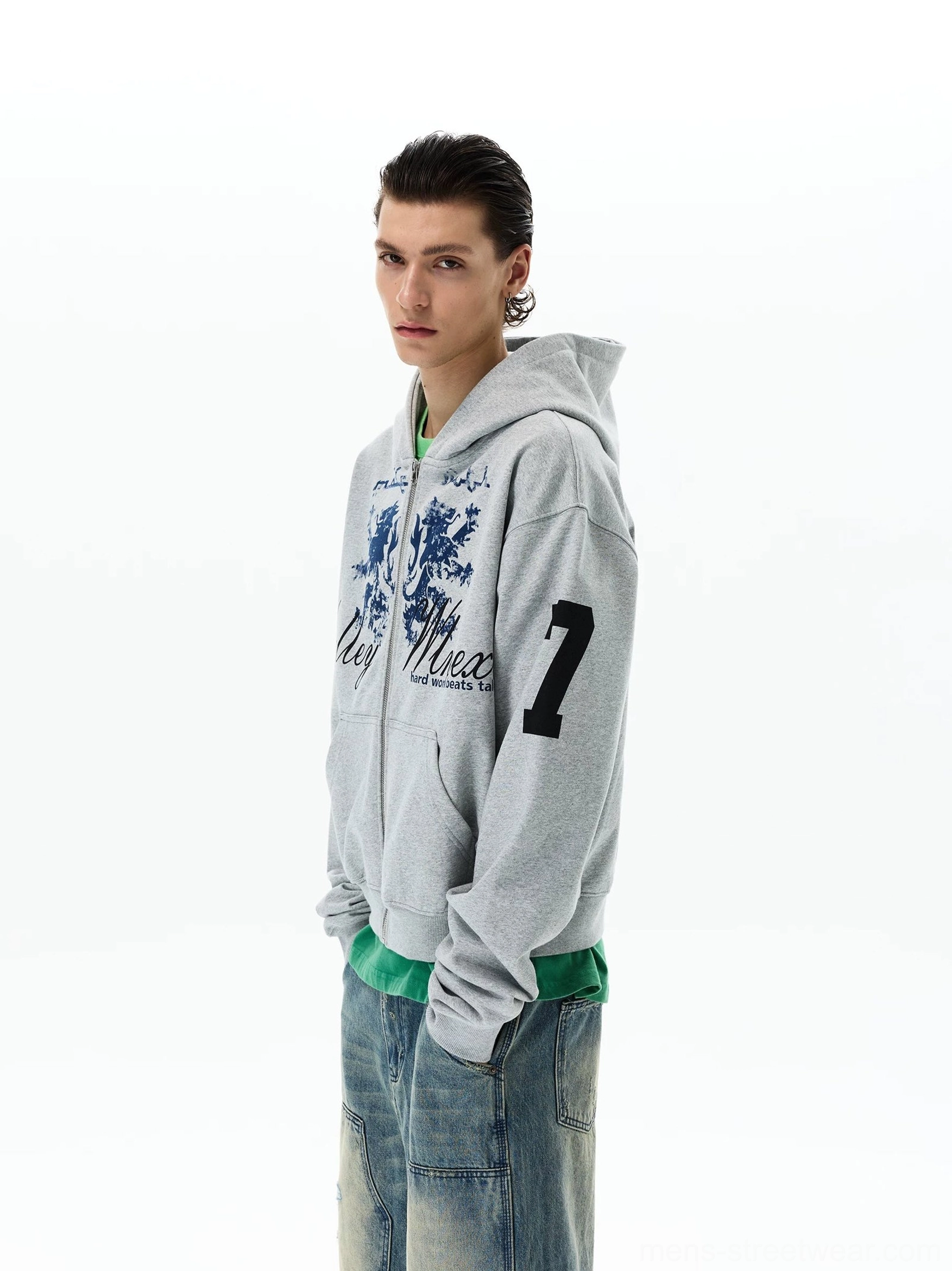 Left three-quarter view of a relaxed heather grey varsity zip-up hoodie with vintage crest print, sleeve number 7, hood, and casual Korean streetwear fit