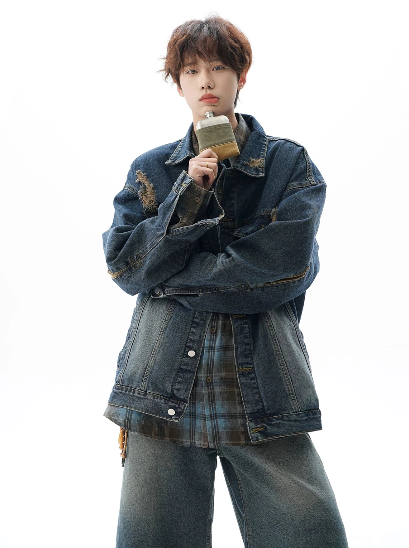 Vintage distressed denim jacket with oversized streetwear proportions, textured washed finish, utility chest pockets, and playful casual character