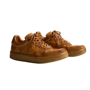 Vintage distressed brown horsehide leather low-top sneakers with perforated toe panels and aged rubber sole side view