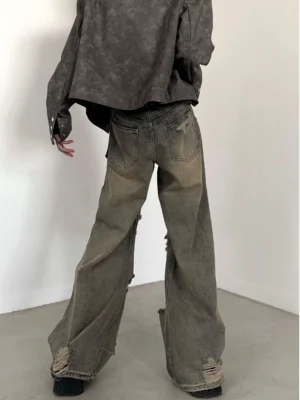 Back view of faded vintage wide-leg denim pants showing relaxed loose fit, classic rear pockets, and frayed hems
