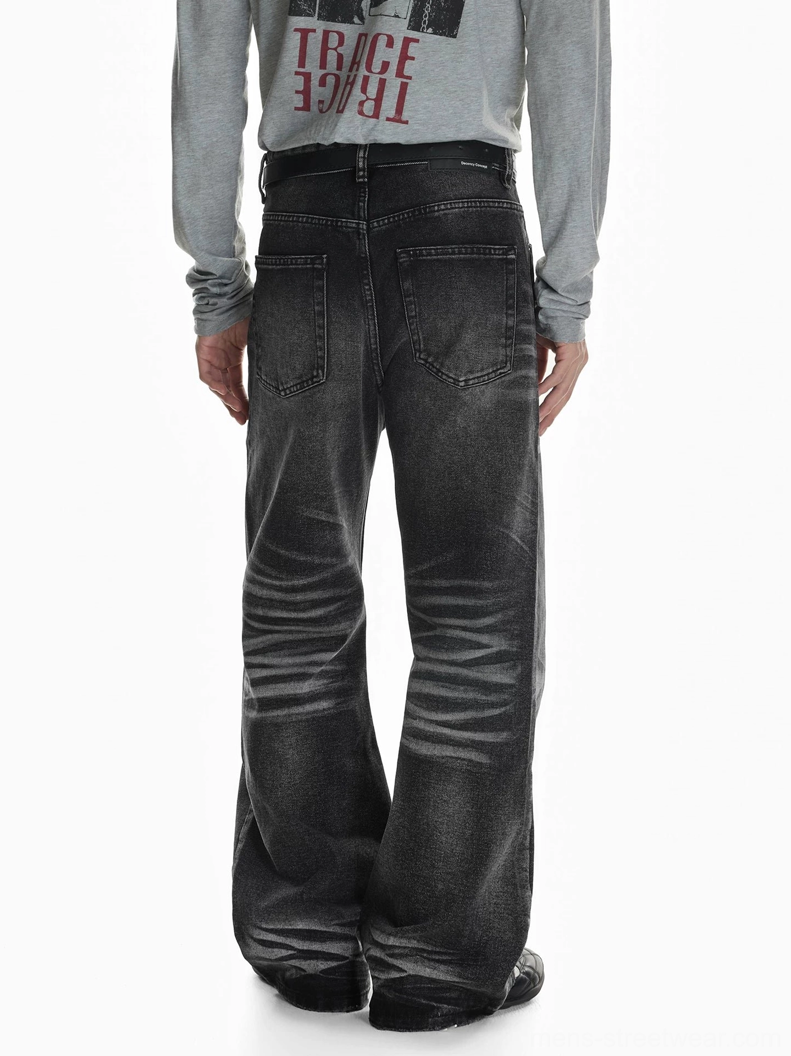Rear view of vintage faded black flare jeans with classic back pockets, back yoke fading, relaxed waist fit, and wide flared legs for modern streetwear styling