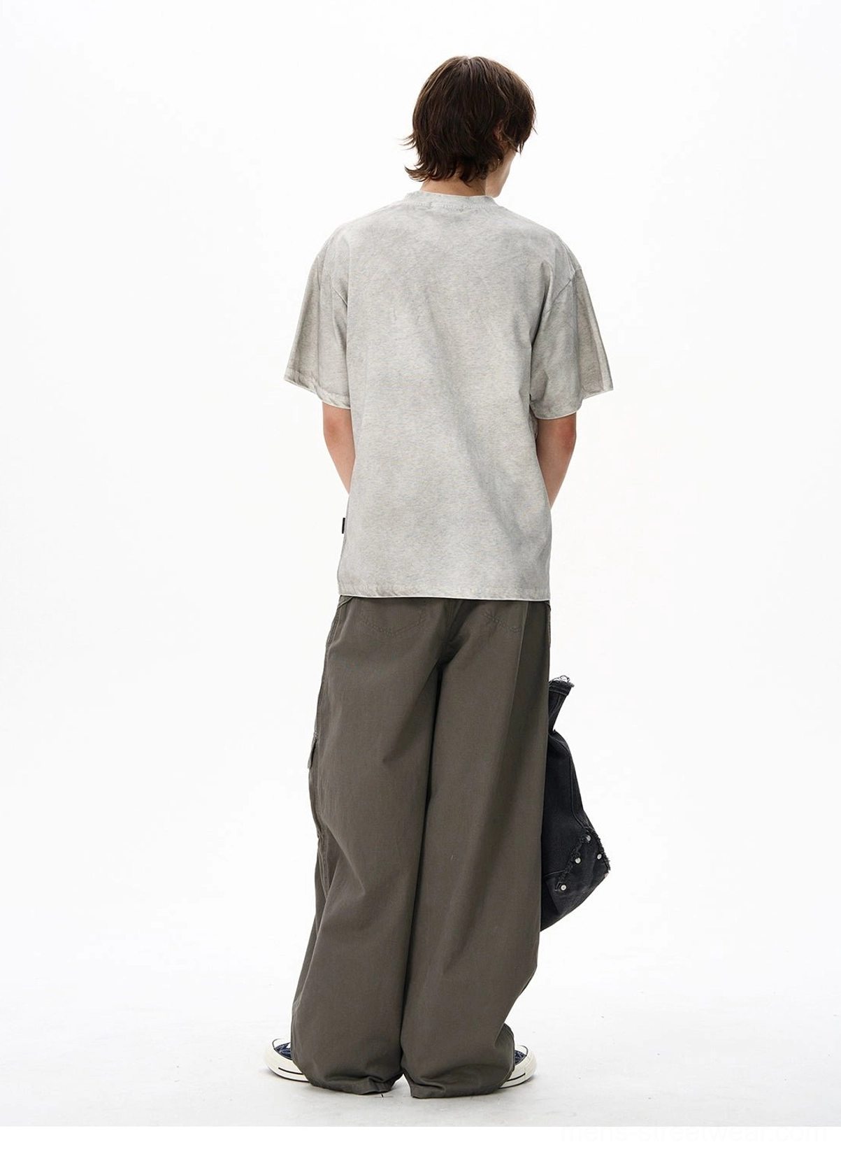 Back view of a washed gray oversized cotton streetwear T-shirt showing the clean solid back and relaxed drop shoulder fit
