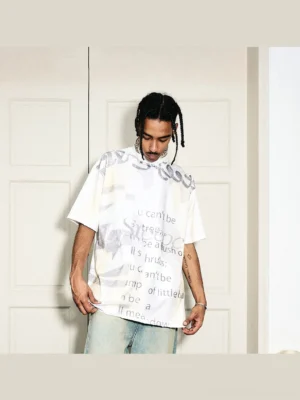 Front view of a cream faded oversized graphic text T-shirt with gray graffiti lettering and relaxed Korean streetwear fit