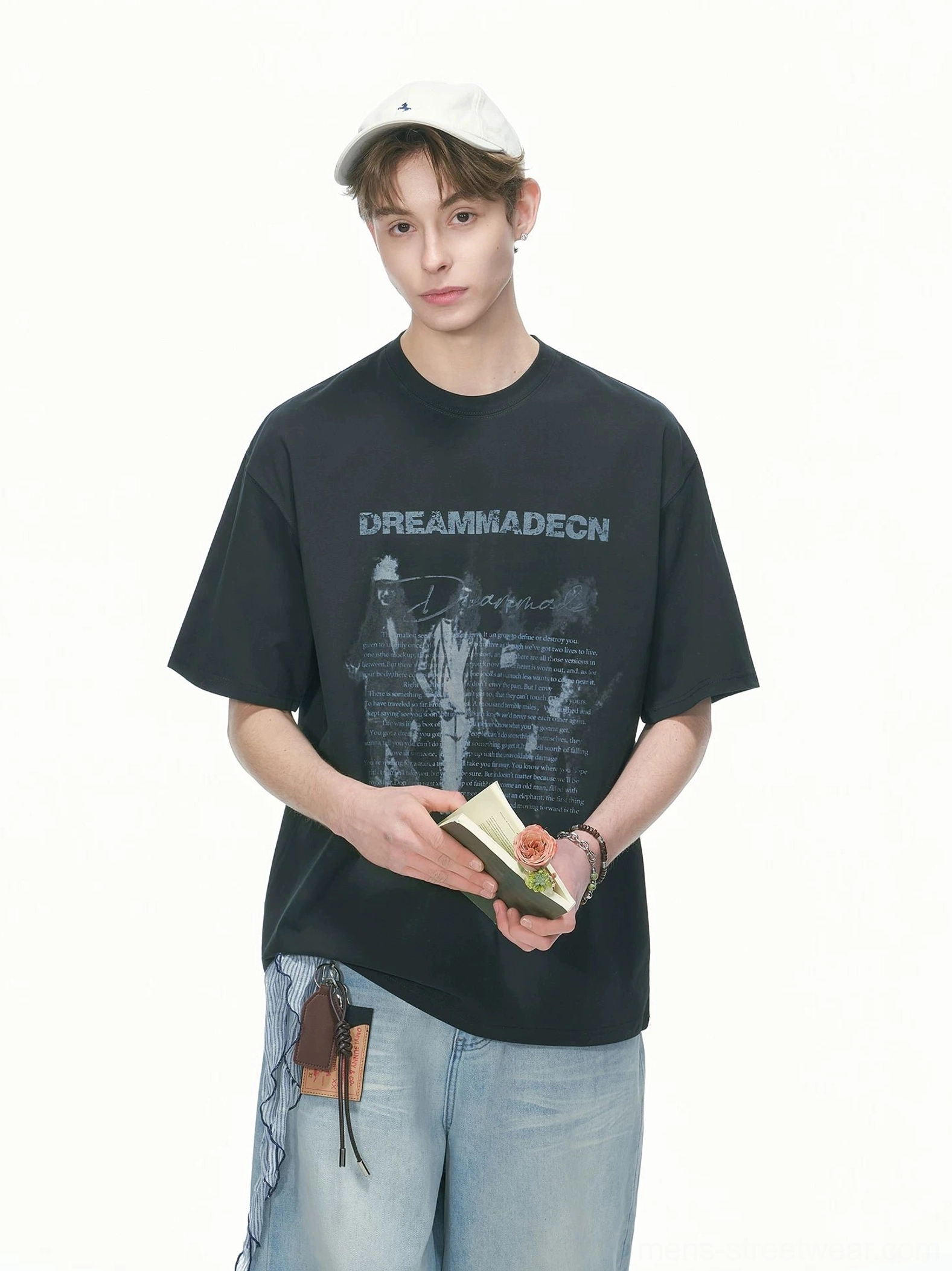 Black vintage graphic oversized T-shirt styled with light wash wide leg denim and a white baseball cap in a Korean streetwear outfit