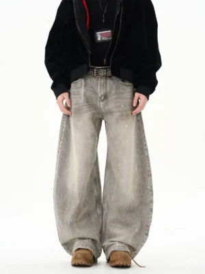 Gray paint splatter wide leg jeans front view styled with a black bomber jacket and brown leather shoes