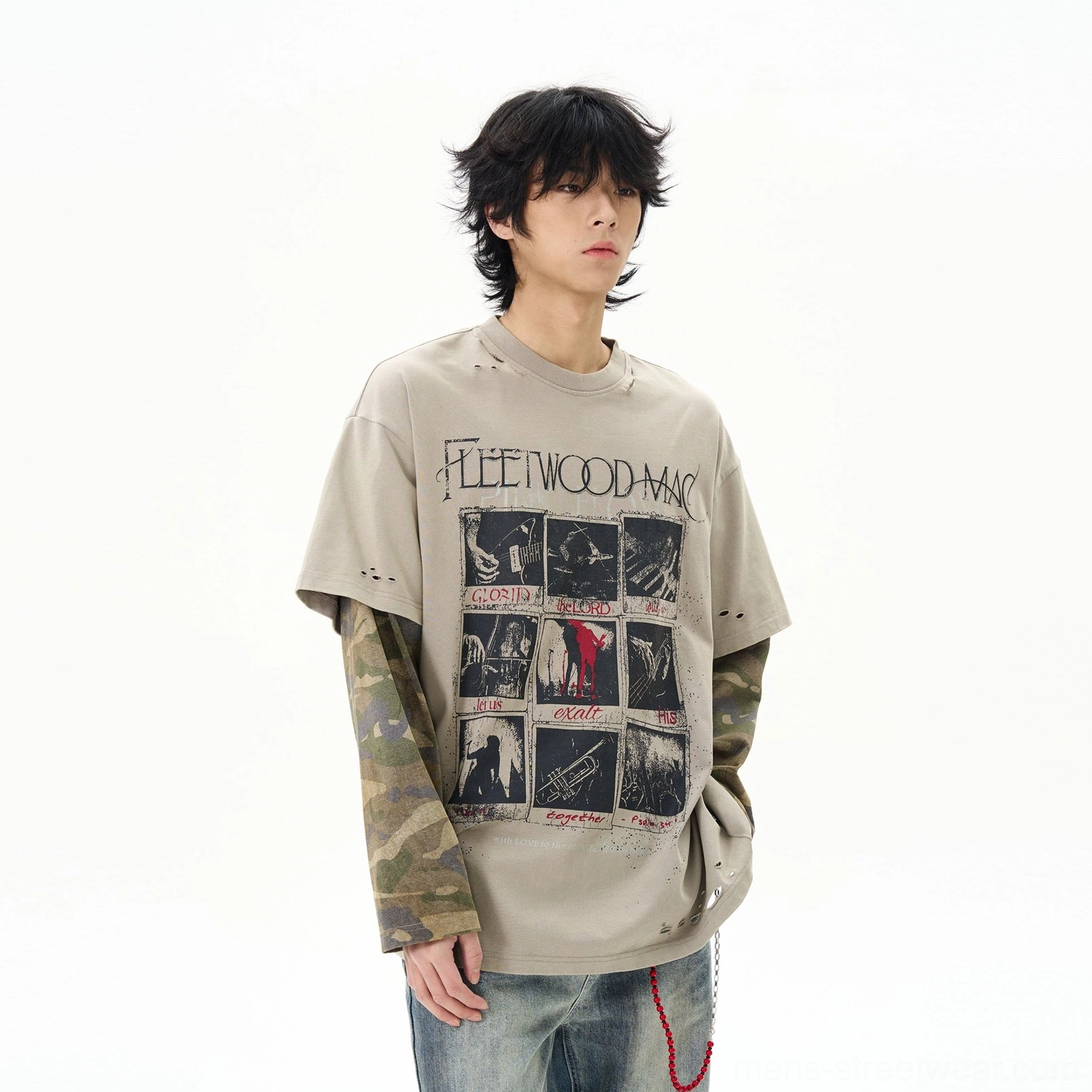 Front three quarter view of khaki vintage graphic oversized t-shirt with camouflage long sleeves and distressed edges