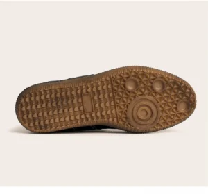 Gum rubber outsole of vintage leather streetwear sneakers showing geometric anti-slip traction pattern