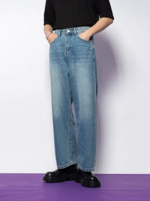 Front full-length view of vintage light blue relaxed straight-leg jeans styled with a black T-shirt and black platform leather shoes