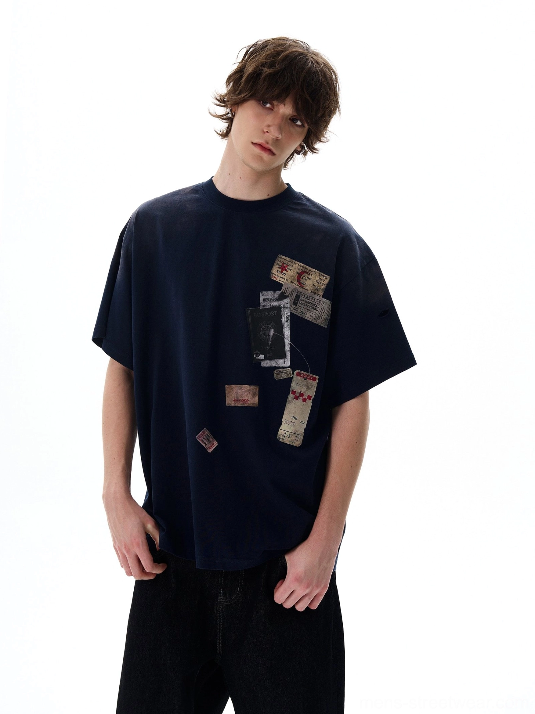 Navy blue passport stamp oversized T-shirt with vintage travel graphic prints styled with black wide-leg trousers in Korean streetwear fashion
