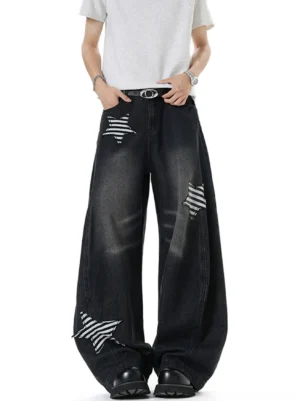 Front view of black wide leg denim jeans featuring striped star patches on both thighs and a relaxed streetwear fit