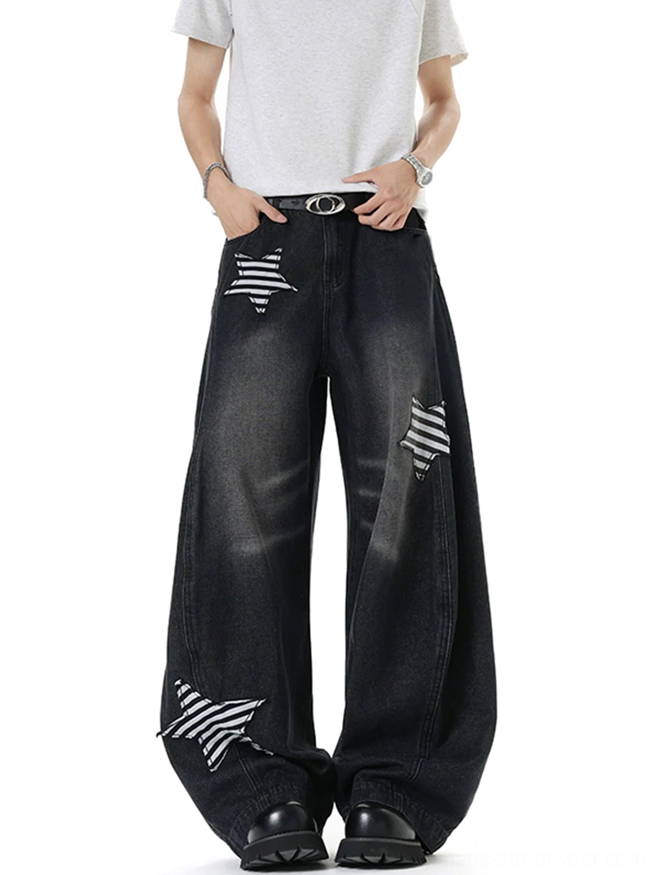 Front view of black wide leg denim jeans featuring striped star patches on both thighs and a relaxed streetwear fit