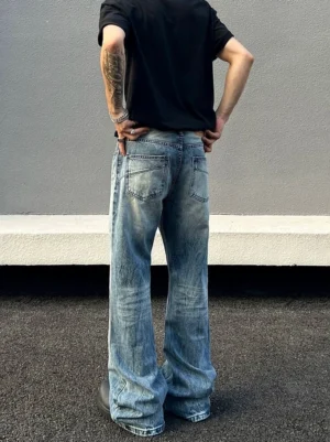 Back view of light blue faded stonewash flared jeans showing classic rear pockets and vintage denim wash texture