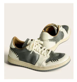 Vintage two-tone horsehide leather sneakers in grey and off-white with hand-stitched decorative seams and a retro low-top streetwear silhouette