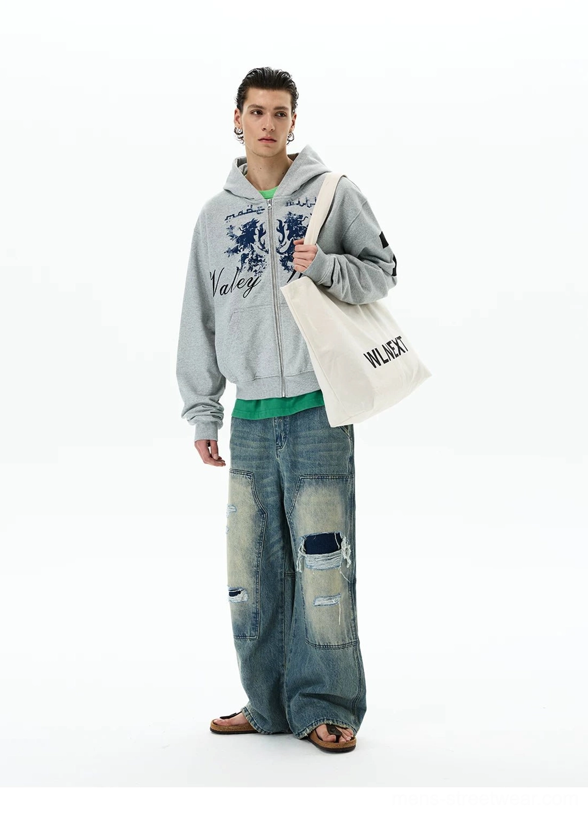 Right three-quarter view of a vintage varsity grey zip-up hoodie with front crest print, attached hood, relaxed silhouette, and casual urban styling